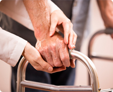 elderly with hands on walker