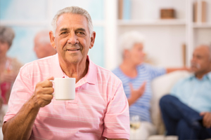 senior drinking coffee in an assisted living facility
