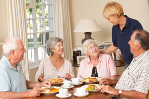 elderly people dining together